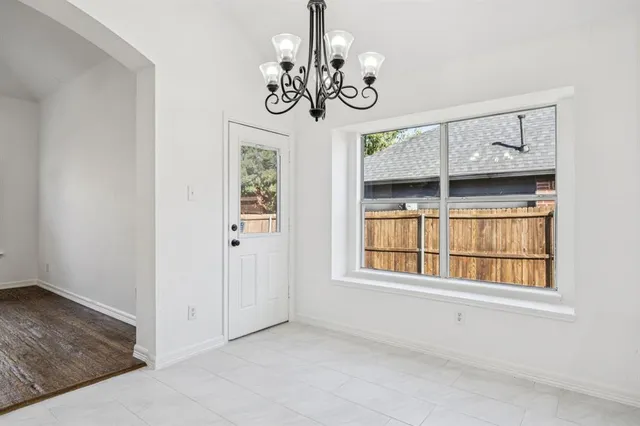 a view of a room with a window and chandelier