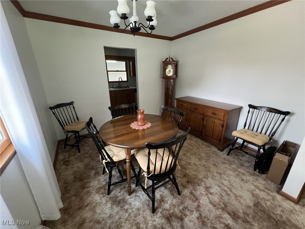 7579 McCreary Road Independence, OH 44131 - Photo 4 of 33 Dining space with a chandelier, ornamental molding, and carpet floors