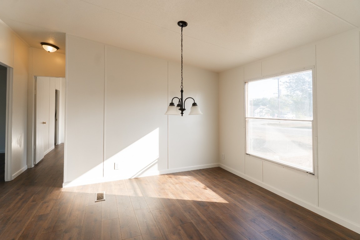 404 South Mill Street Flatonia, TX 78941 - Photo 15 of 34 a view of a room with wooden floor and a ceiling fan