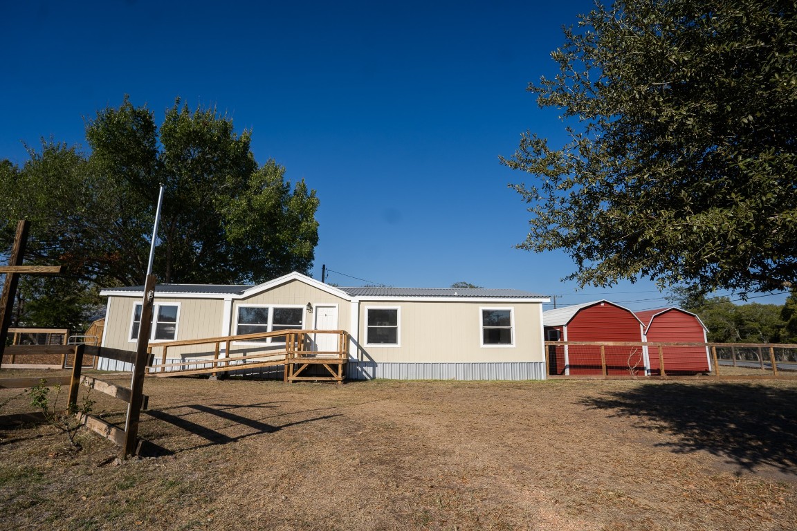 404 South Mill Street Flatonia, TX 78941 - Photo 3 of 34 a white house with a yard plants and large tree