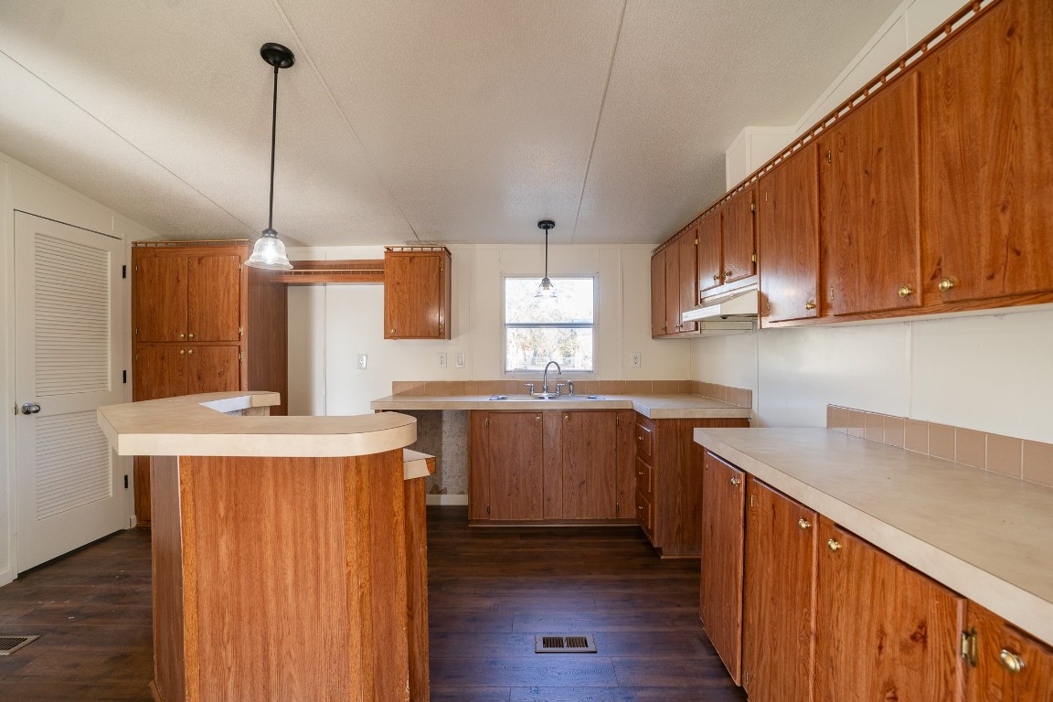 404 South Mill Street Flatonia, TX 78941 - Photo 10 of 34 a kitchen with stainless steel appliances granite countertop a sink a stove a refrigerator cabinets and wooden floor