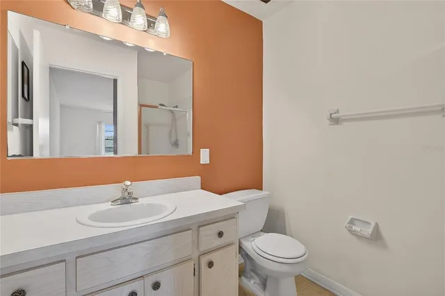 a bathroom with a sink a toilet and mirror