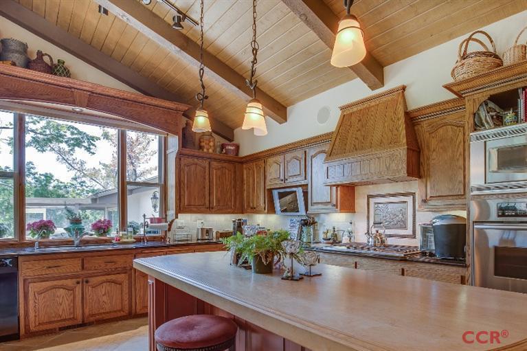 a kitchen with a sink appliances and a counter top space