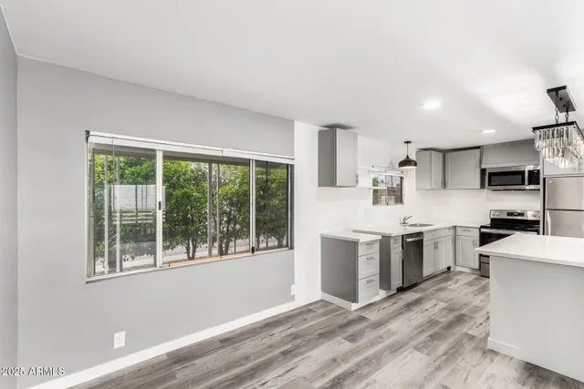 a kitchen with stainless steel appliances granite countertop a stove and a sink