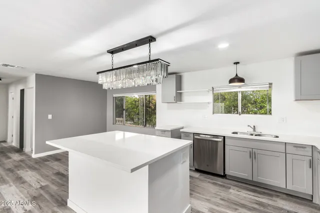 a kitchen with stainless steel appliances a sink a stove and a window