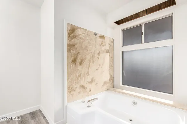 a bathroom with a bathtub and shower