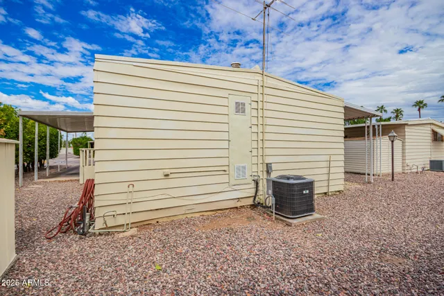 a view of a backyard with plants and a patio