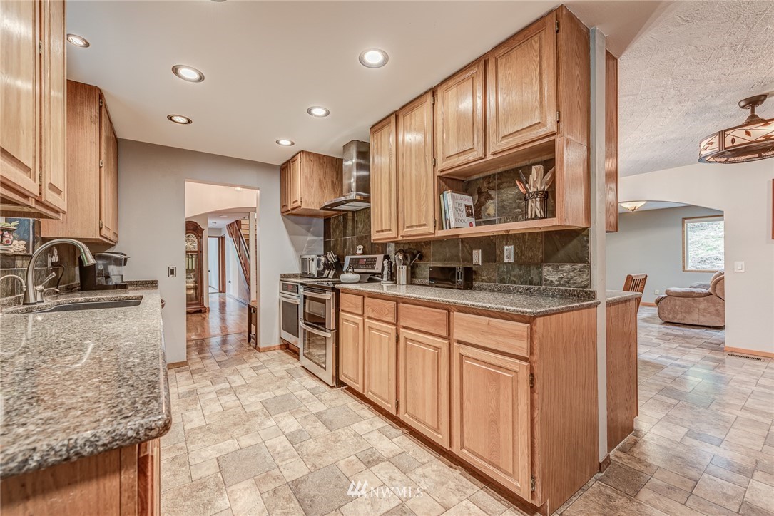 20600 2nd Avenue Southwest Normandy Park, WA 98166 - Photo 22 of 40 a kitchen with stainless steel appliances granite countertop a refrigerator and a sink