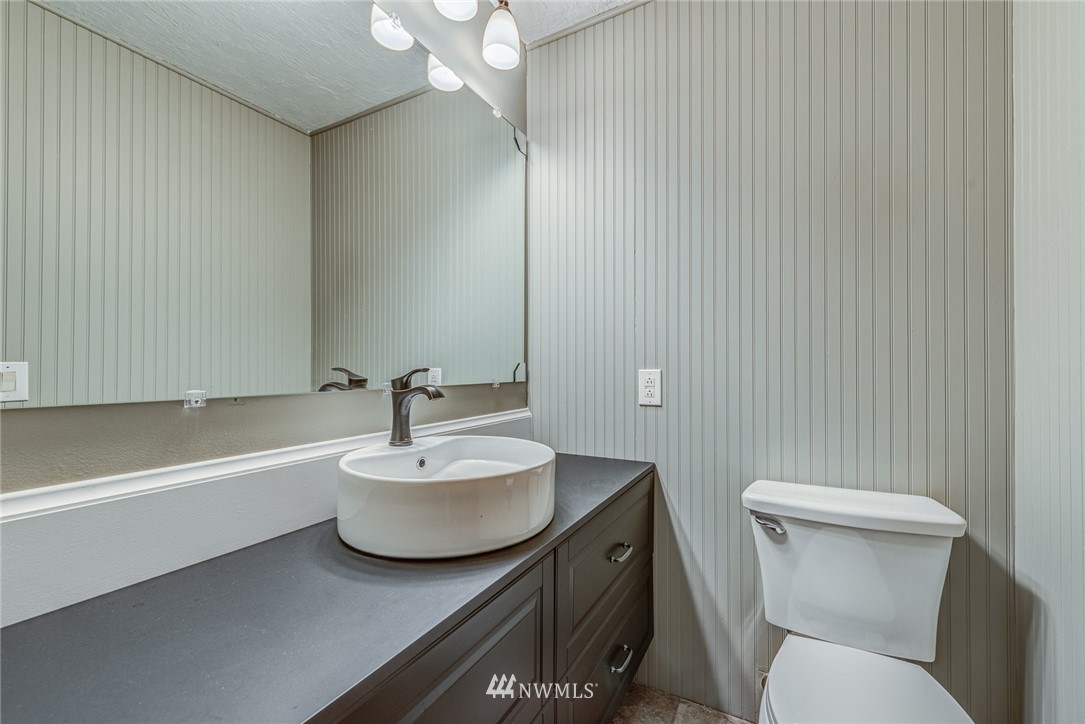20600 2nd Avenue Southwest Normandy Park, WA 98166 - Photo 25 of 40 a bathroom with a sink a mirror and a toilet
