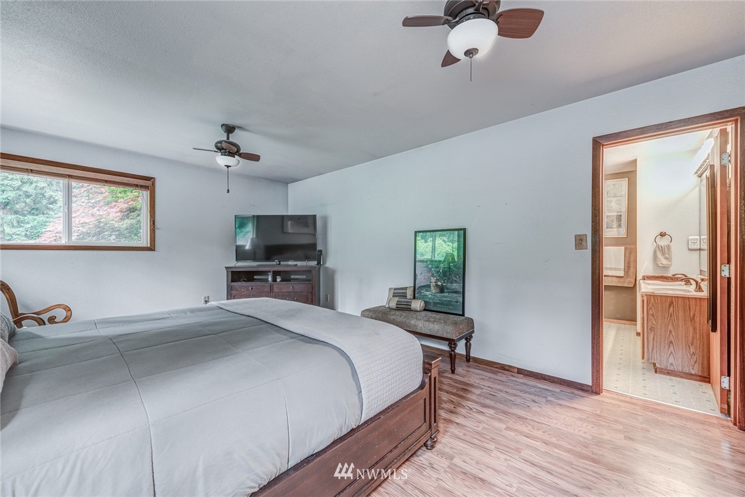 20600 2nd Avenue Southwest Normandy Park, WA 98166 - Photo 31 of 40 a bedroom with a bed and a chandelier
