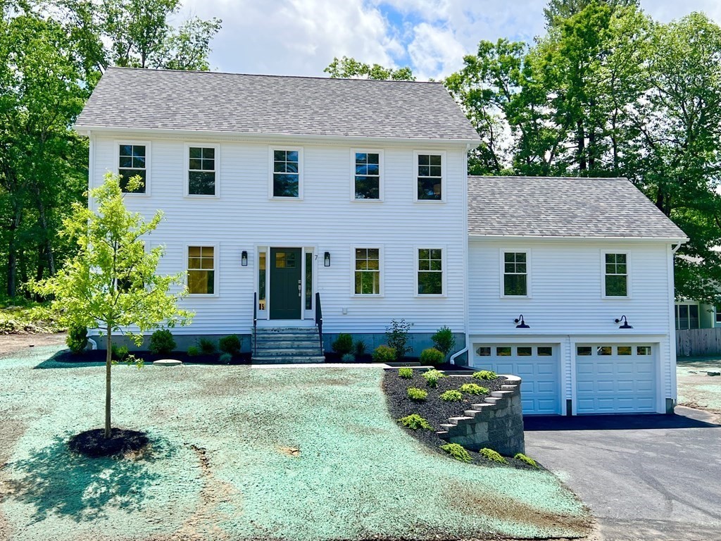 7 Sandy Pond Road Ayer, MA 01432 - Photo 1 of 22 a front view of a house with a garden and plants