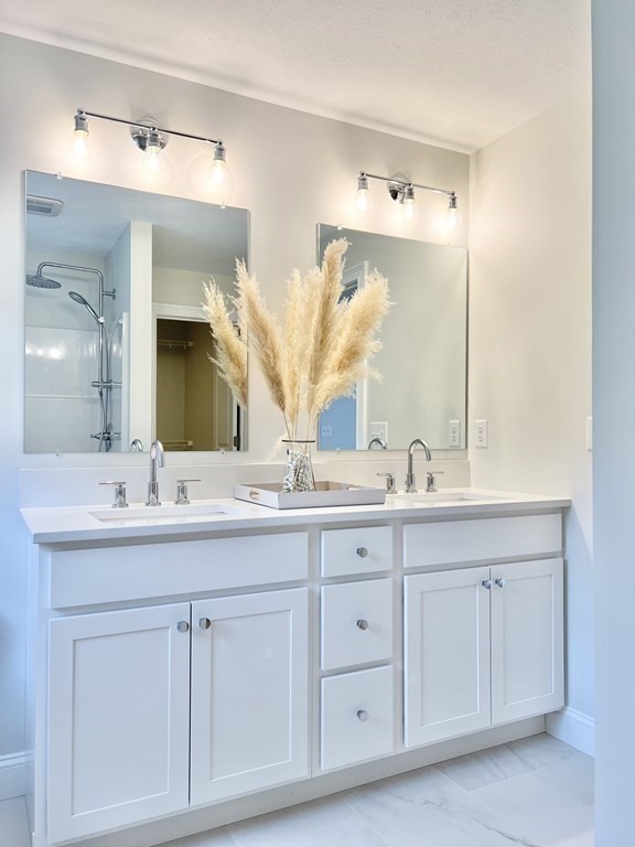 7 Sandy Pond Road Ayer, MA 01432 - Photo 16 of 22 a bathroom with a double vanity sink and mirror