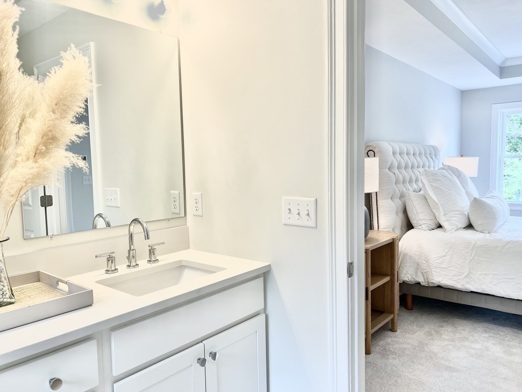 7 Sandy Pond Road Ayer, MA 01432 - Photo 17 of 22 a en suite bathroom with a double vanity sink and a mirror