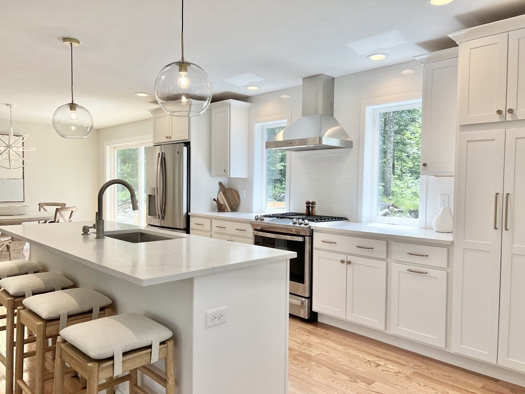 7 Sandy Pond Road Ayer, MA 01432 - Photo 7 of 22 a kitchen with granite countertop a sink a center island and cabinets