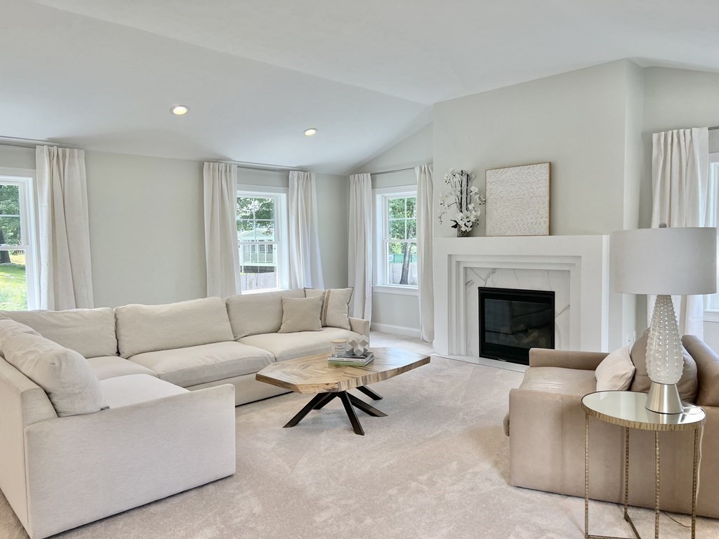 7 Sandy Pond Road Ayer, MA 01432 - Photo 9 of 22 a living room with furniture and a fireplace