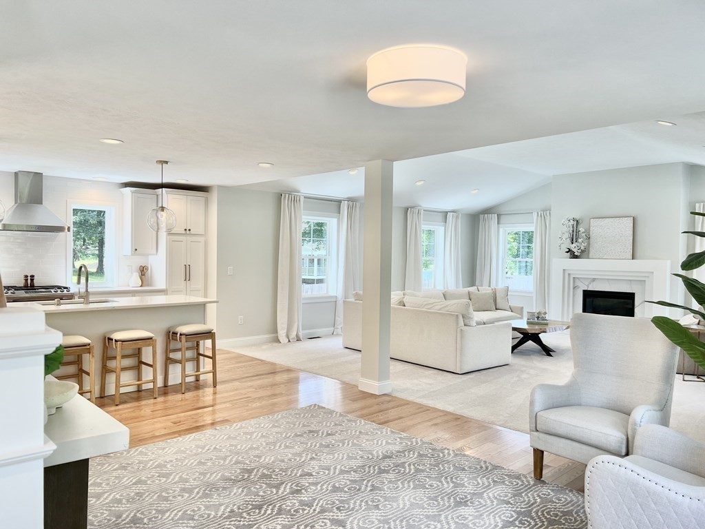 7 Sandy Pond Road Ayer, MA 01432 - Photo 10 of 22 a living room with fireplace furniture and a wooden floor