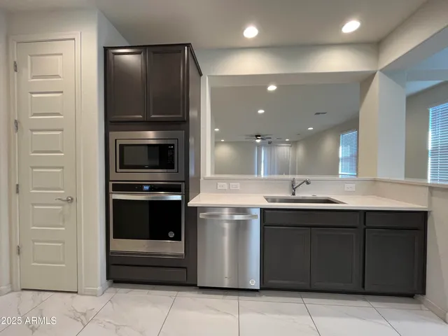 a kitchen with a sink and stainless steel appliances