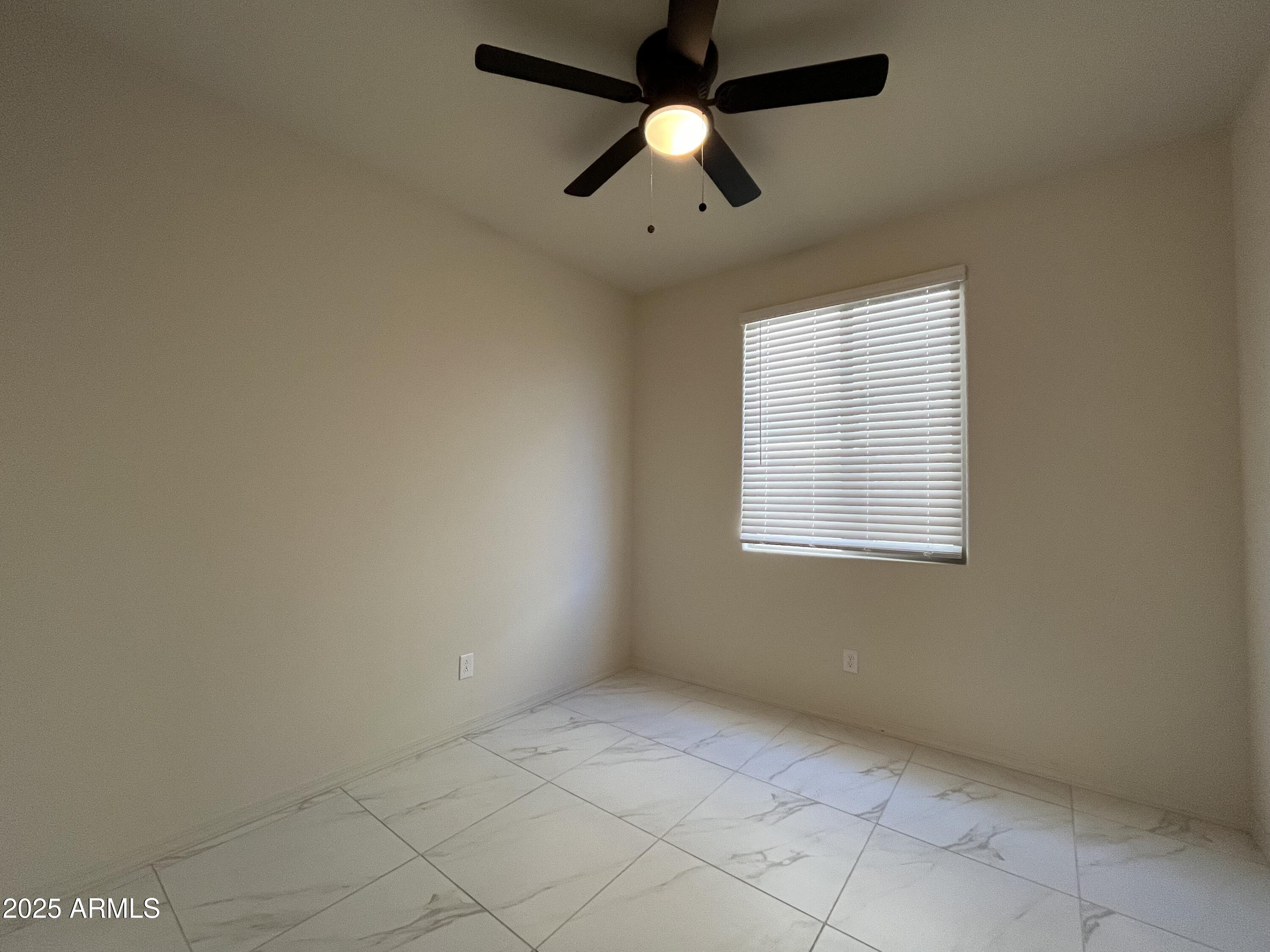 6970 West Gwen Street Laveen, AZ 85339 - Photo 13 of 30 an empty room with a window and a fan