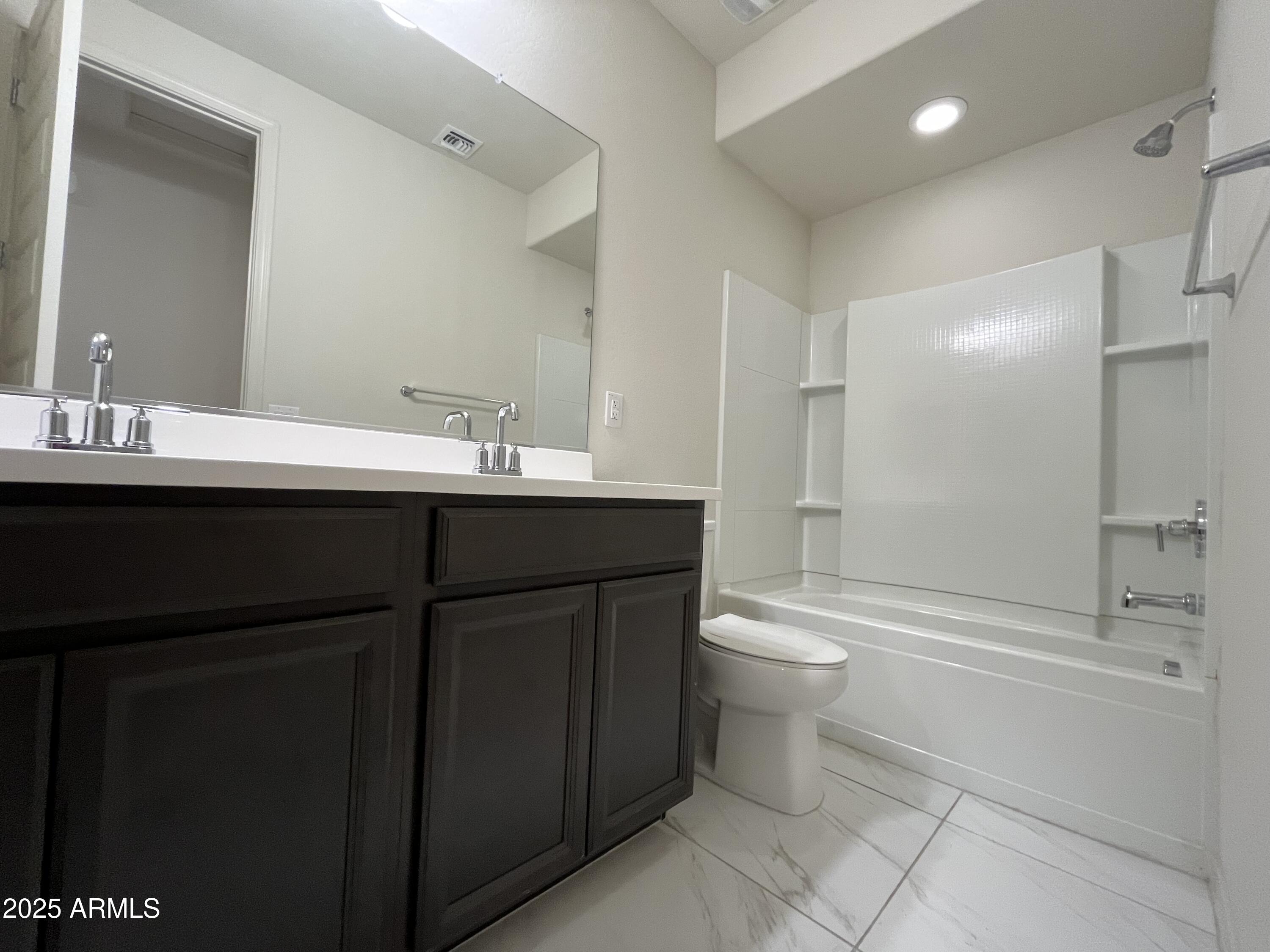 6970 West Gwen Street Laveen, AZ 85339 - Photo 17 of 30 a bathroom with a double vanity sink toilet and shower