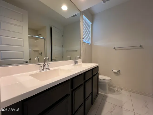a bathroom with a glass shower door