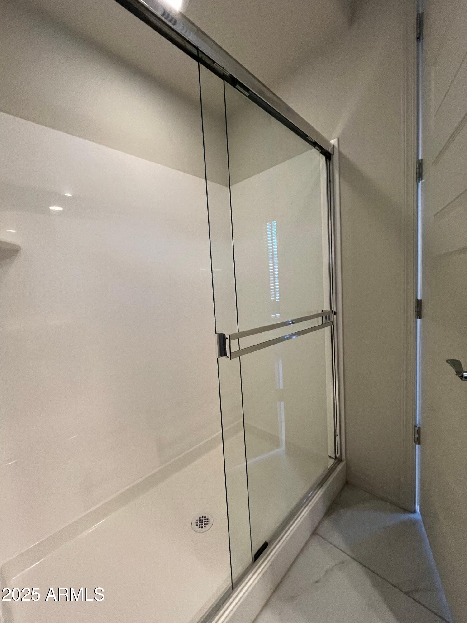 6970 West Gwen Street Laveen, AZ 85339 - Photo 24 of 30 a bathroom with a glass shower door