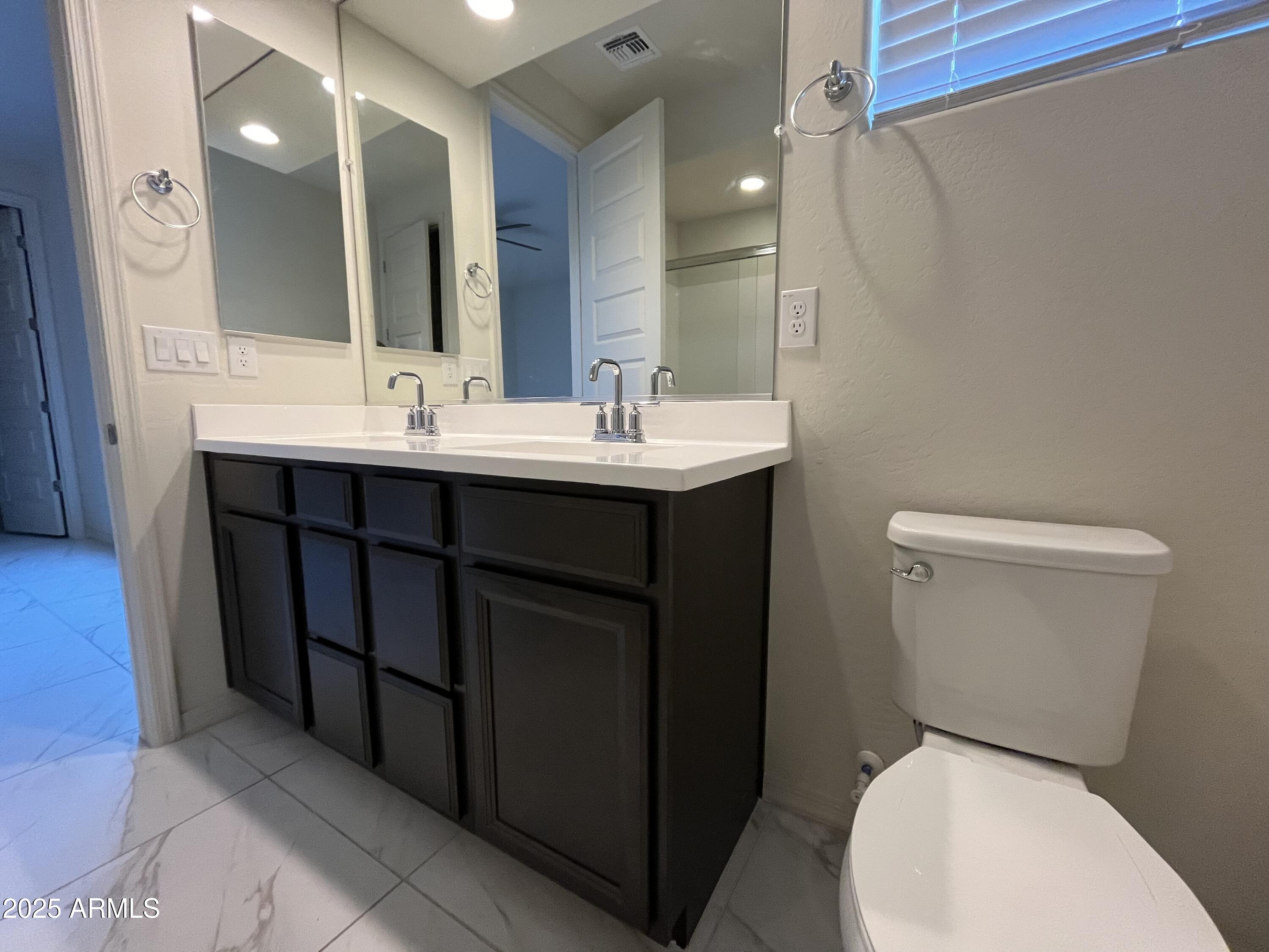 6970 West Gwen Street Laveen, AZ 85339 - Photo 25 of 30 a bathroom with a toilet sink and mirror