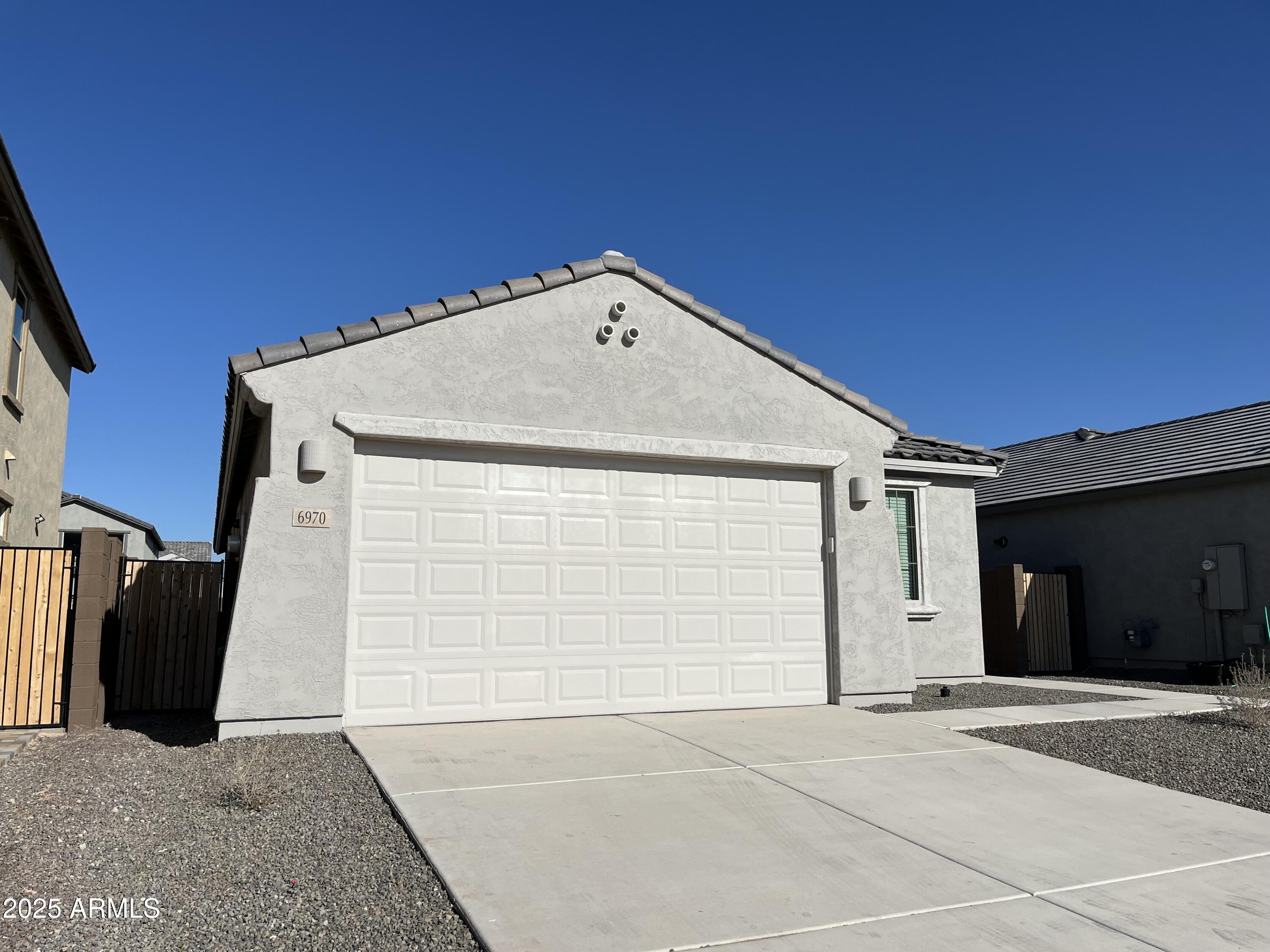 6970 West Gwen Street Laveen, AZ 85339 - Photo 3 of 30 a front view of a house with garage