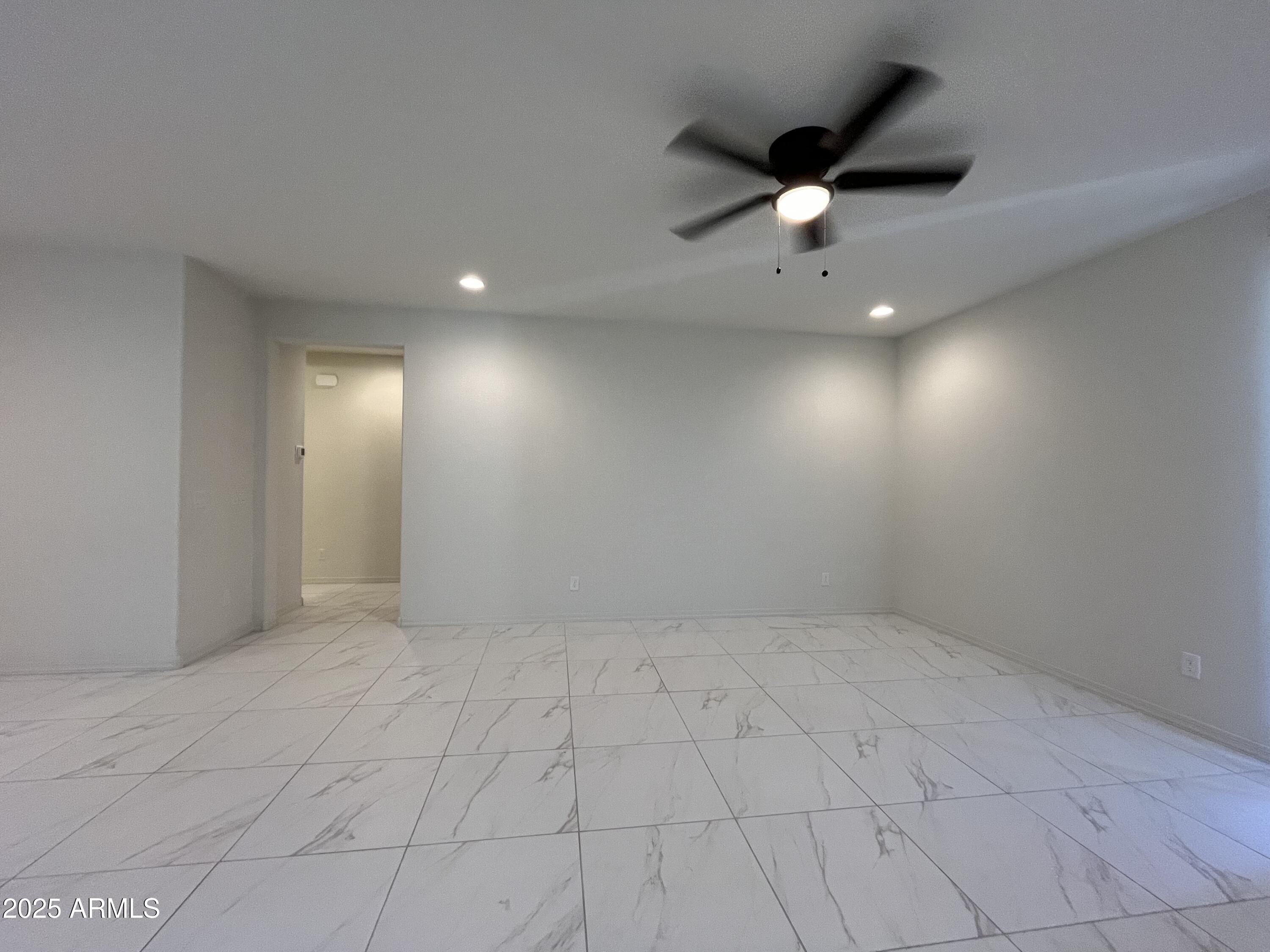 6970 West Gwen Street Laveen, AZ 85339 - Photo 5 of 30 an empty room with fan and windows