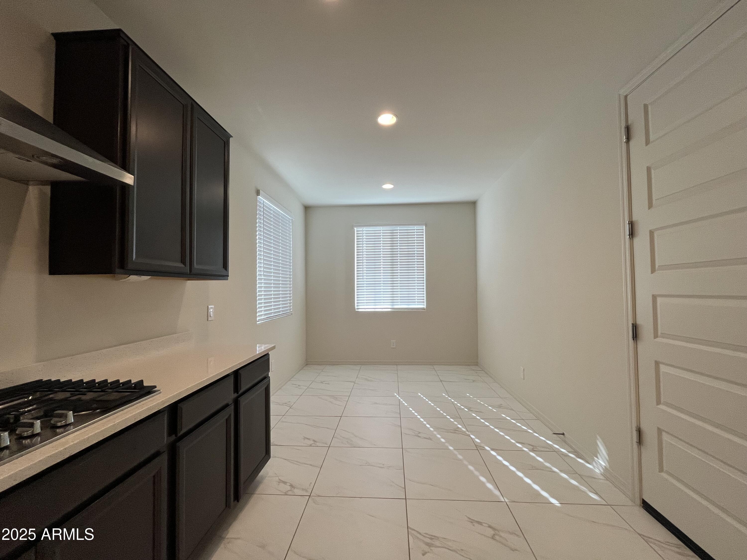 6970 West Gwen Street Laveen, AZ 85339 - Photo 8 of 30 a kitchen with a stove and a microwave