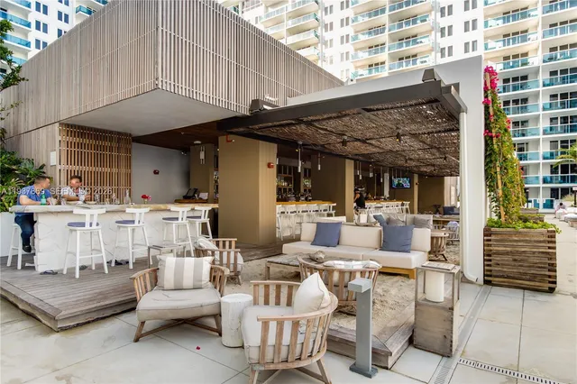 a view of the patio with dining table and chairs with wooden floor and fence
