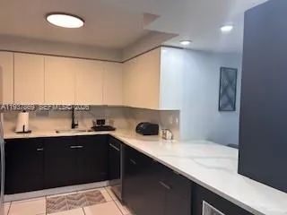 a kitchen with a sink and cabinets
