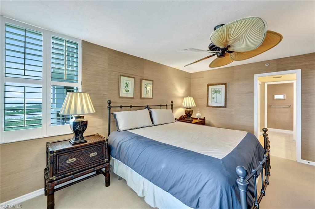 6573 Marissa Loop, Unit 2003 Naples, FL 34108 - Photo 14 of 41 a bedroom with a bed lamp and window