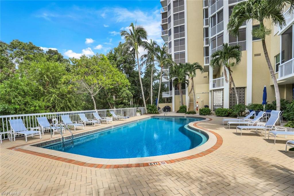 6573 Marissa Loop, Unit 2003 Naples, FL 34108 - Photo 28 of 41 a view of a swimming pool with a lounge chair