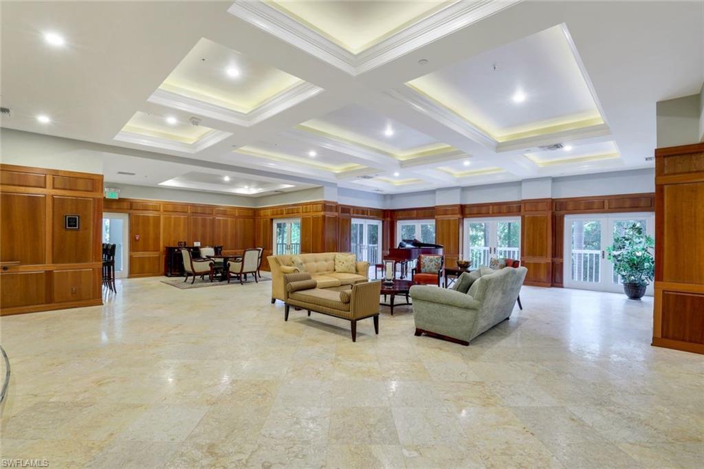 6573 Marissa Loop, Unit 2003 Naples, FL 34108 - Photo 32 of 41 a living room with furniture and a large window