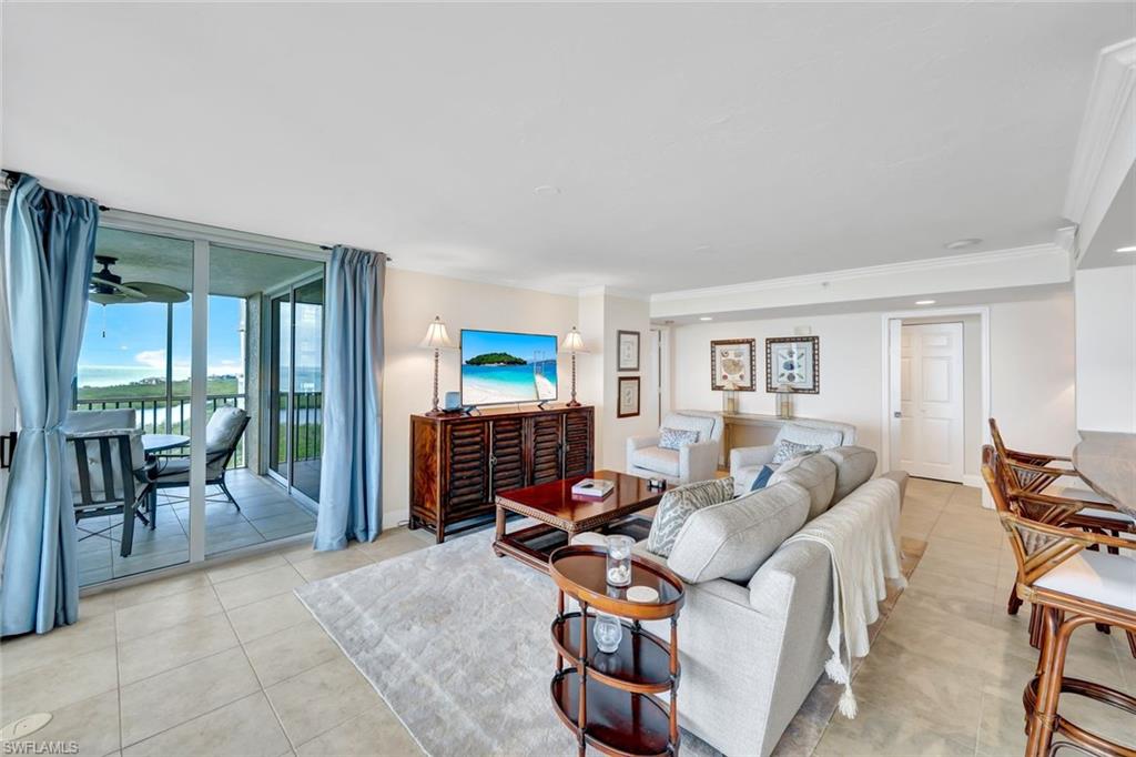 6573 Marissa Loop, Unit 2003 Naples, FL 34108 - Photo 5 of 41 a living room with furniture a dining table and a large window