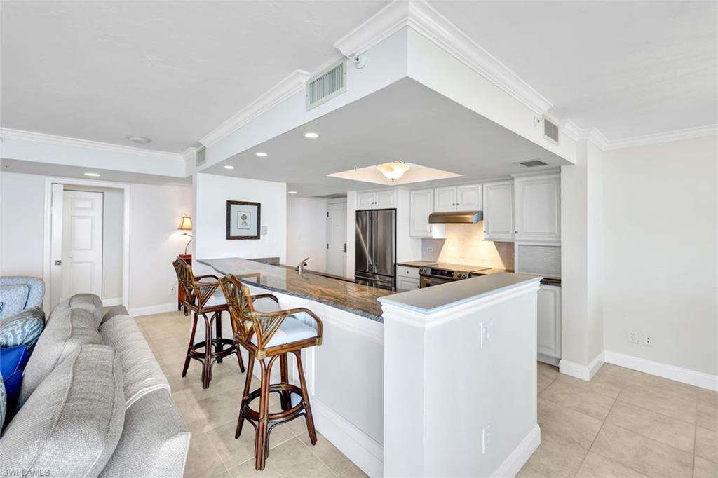 6573 Marissa Loop, Unit 2003 Naples, FL 34108 - Photo 8 of 41 a view of a kitchen and dining room