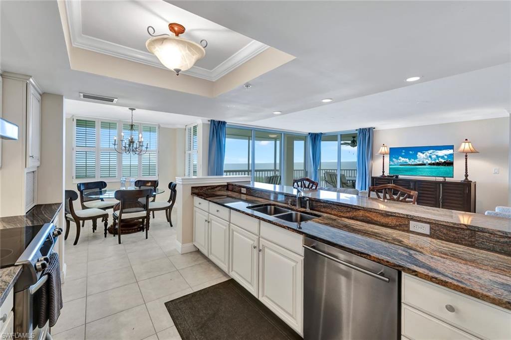 6573 Marissa Loop, Unit 2003 Naples, FL 34108 - Photo 10 of 41 a kitchen with stove and cabinets