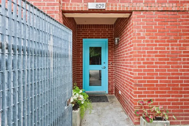a front view of a building with a garden