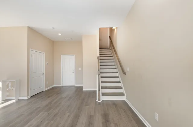 a view of a room with wooden floor