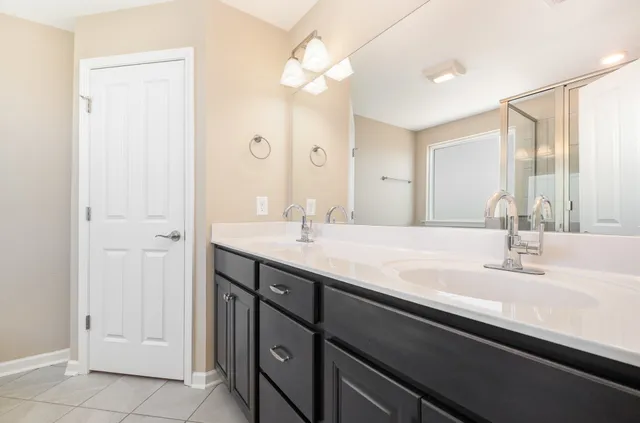 a bathroom with a double vanity sink a vanity and a mirror