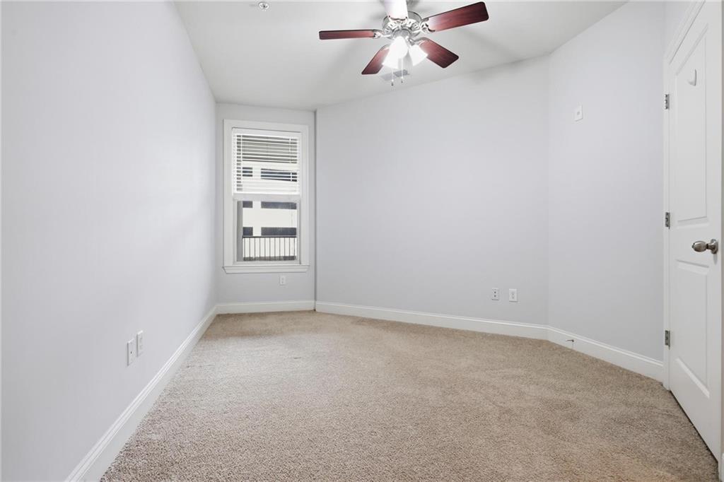 901 Abernathy Road Northeast, Unit 3080 Atlanta, GA 30328 - Photo 13 of 21 an empty room with windows and fan