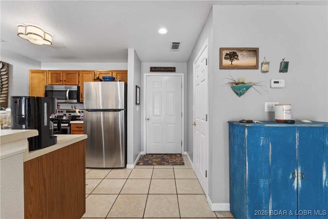 100 Osage Hills Road, Unit 201 Lake Ozark, MO 65049 - Photo 4 of 42 kitchen to front door