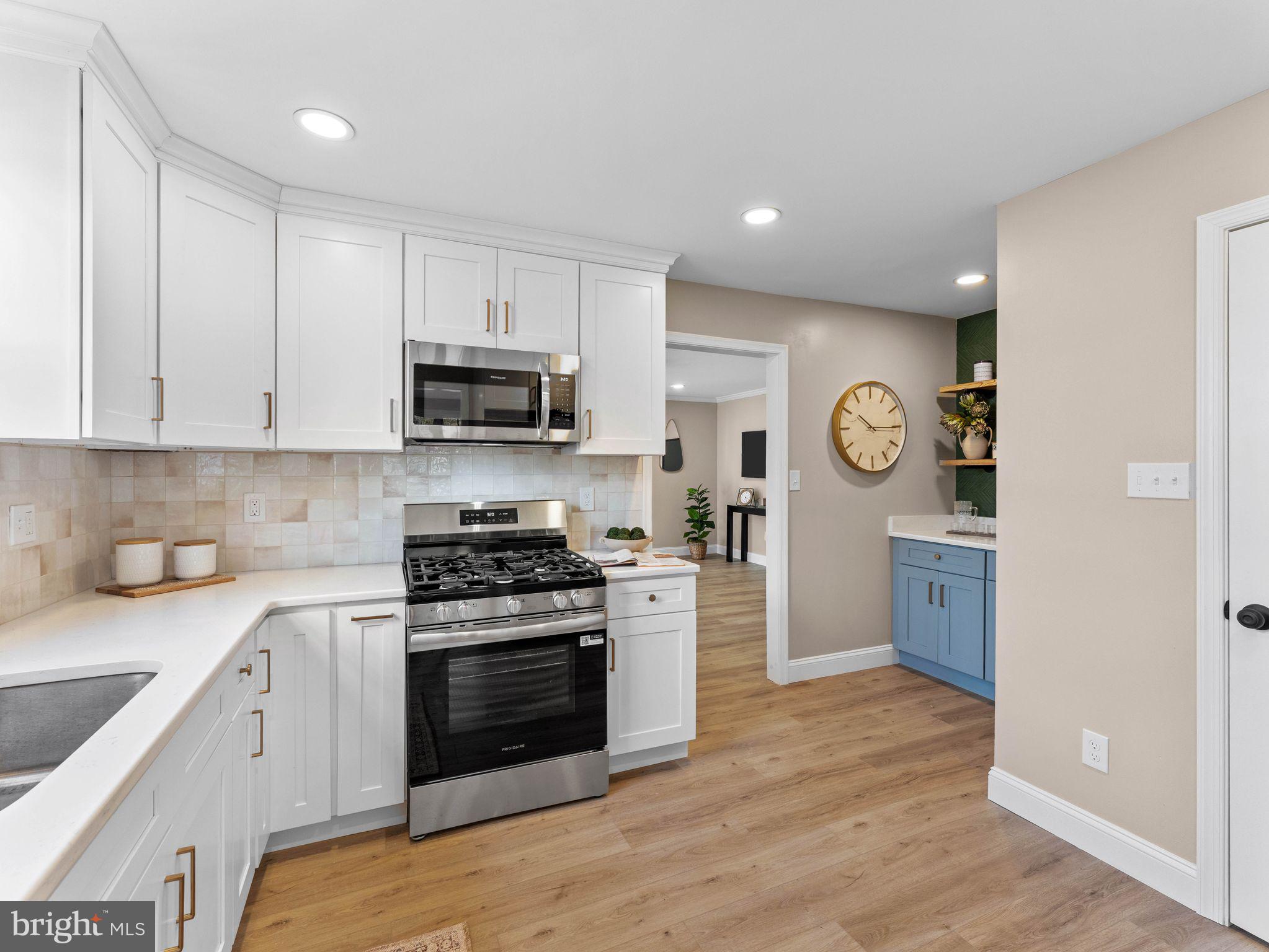 800 Bentley Road Lindenwold, NJ 08021 - Photo 6 of 32 a kitchen with granite countertop a stove top oven sink and cabinets
