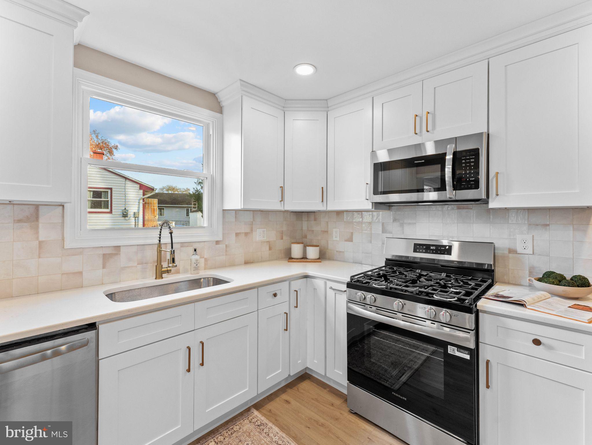 800 Bentley Road Lindenwold, NJ 08021 - Photo 7 of 32 a kitchen with cabinets stainless steel appliances a sink and a window