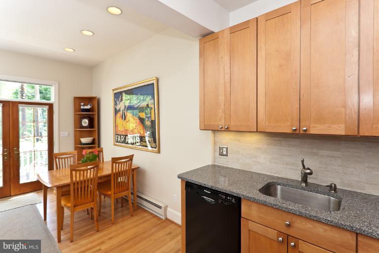 4229 Wickford Road Baltimore, MD 21210 - Photo 20 of 30 a kitchen with stainless steel appliances granite countertop white cabinets a sink and dishwasher with wooden floor