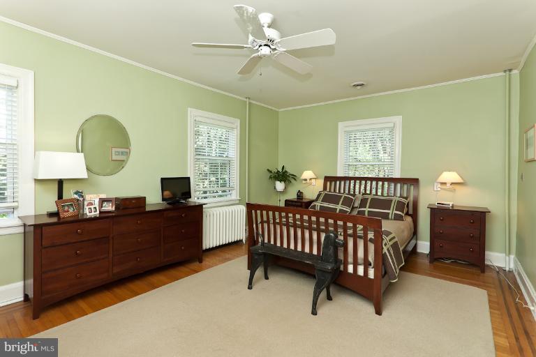 4229 Wickford Road Baltimore, MD 21210 - Photo 9 of 30 a bedroom with a bed and a chandelier