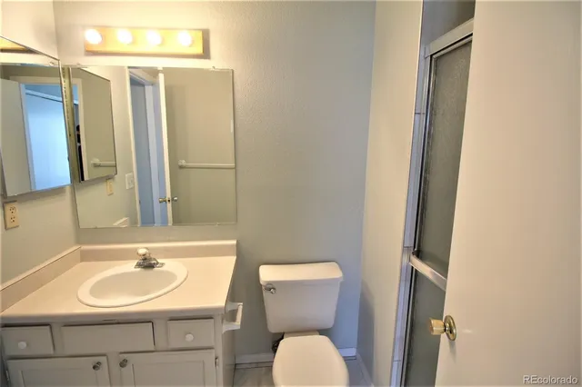 a bathroom with a sink toilet and mirror