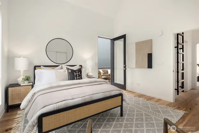 a bedroom with a bed and a painting on the wall