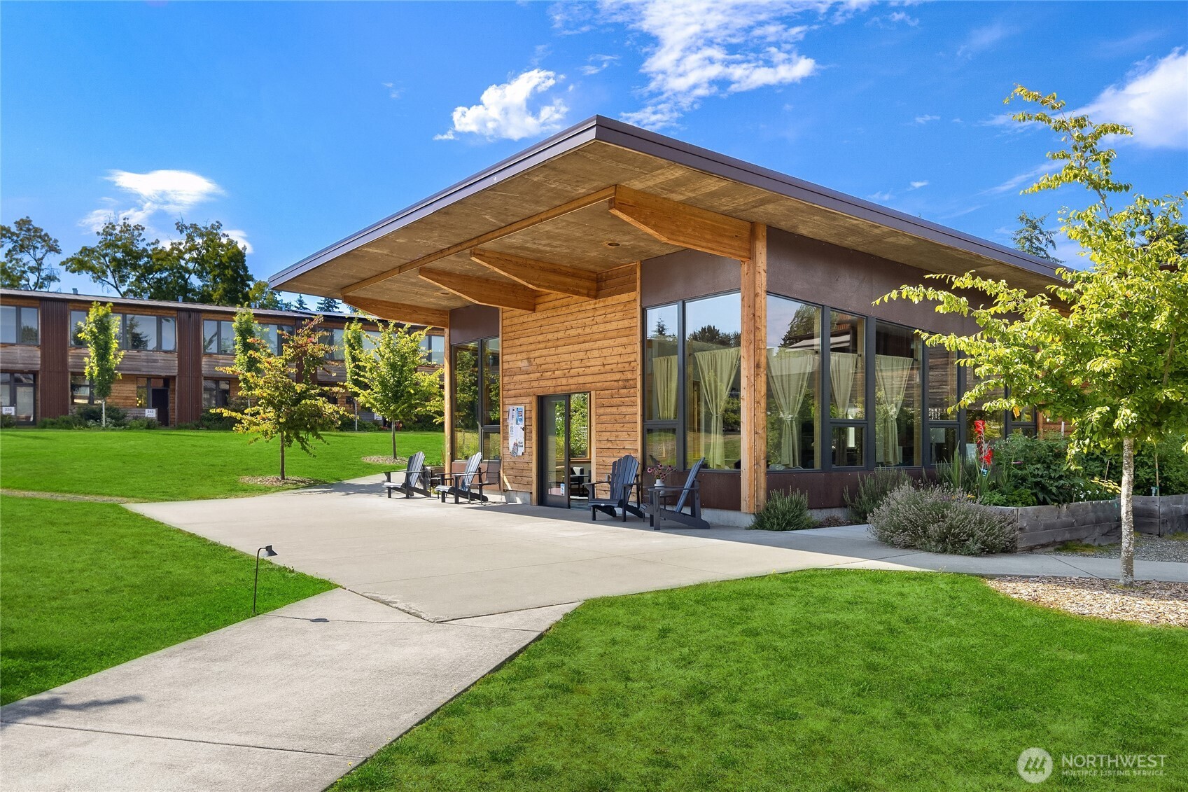 200 Shepard Way Northwest Bainbridge Island, WA 98110 - Photo 19 of 28 a view of a patio with a table and chairs under an umbrella