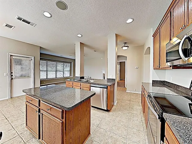 a kitchen with a stove a sink and a refrigerator